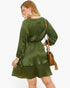 Beach Rose Co. plus size olive green satin V-neck dress with long sleeves and a ruffled hem on a smiling model