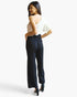 Beach Rose Co. white and black one-shoulder jumpsuit with wide-leg pants and paperbag waist on a model