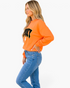 Beach Rose Co. orange sweatshirt with SPOOKY ghost graphic and polka-dot trim worn by a blonde model in profile.