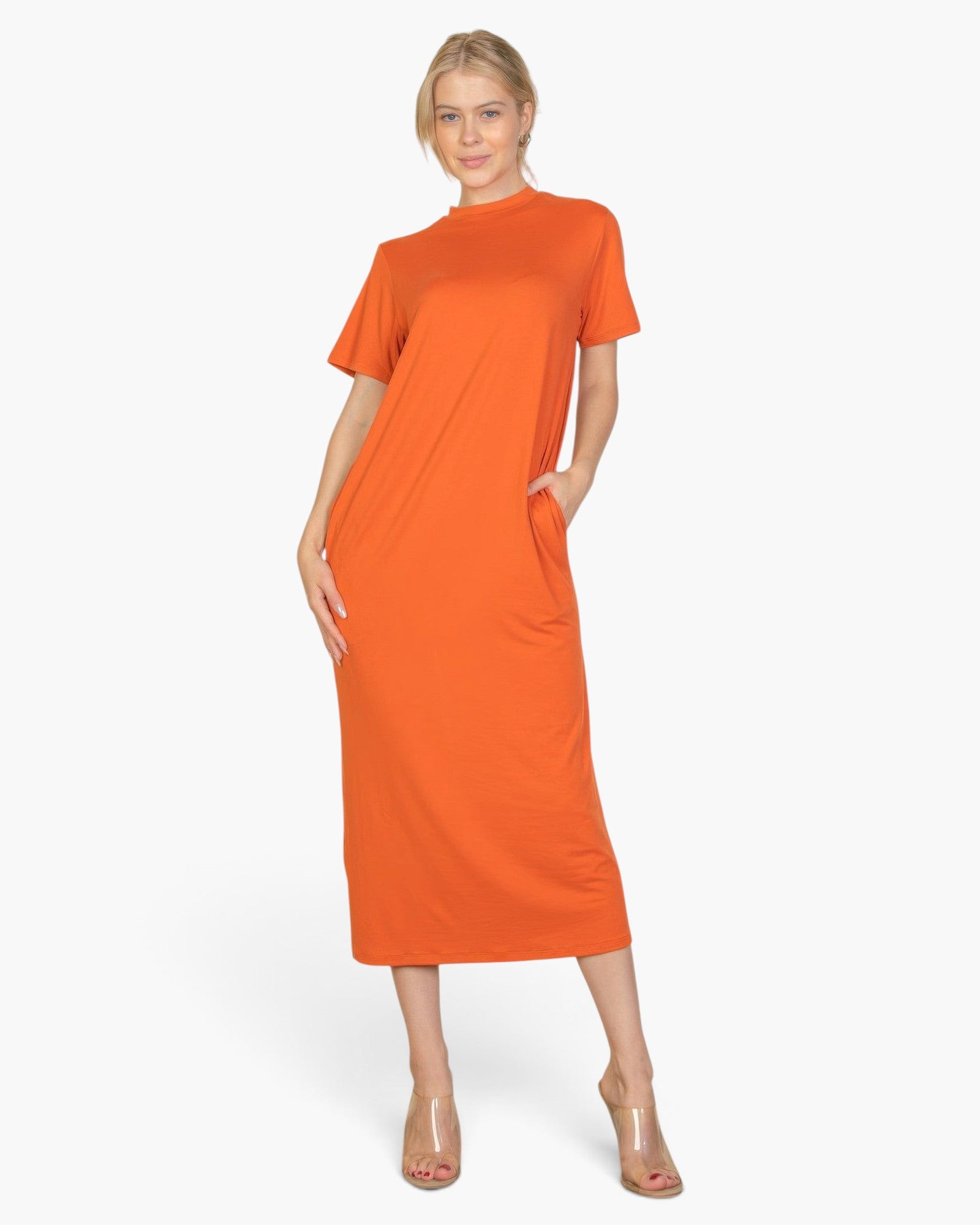 Beach Rose Co. model wearing a vibrant orange midi tee dress in soft stretch jersey fabric with convenient side pockets.