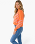 Beach Rose Co. model wearing an orange and pink striped mock-neck sweater with dropped shoulders and ribbed hem.