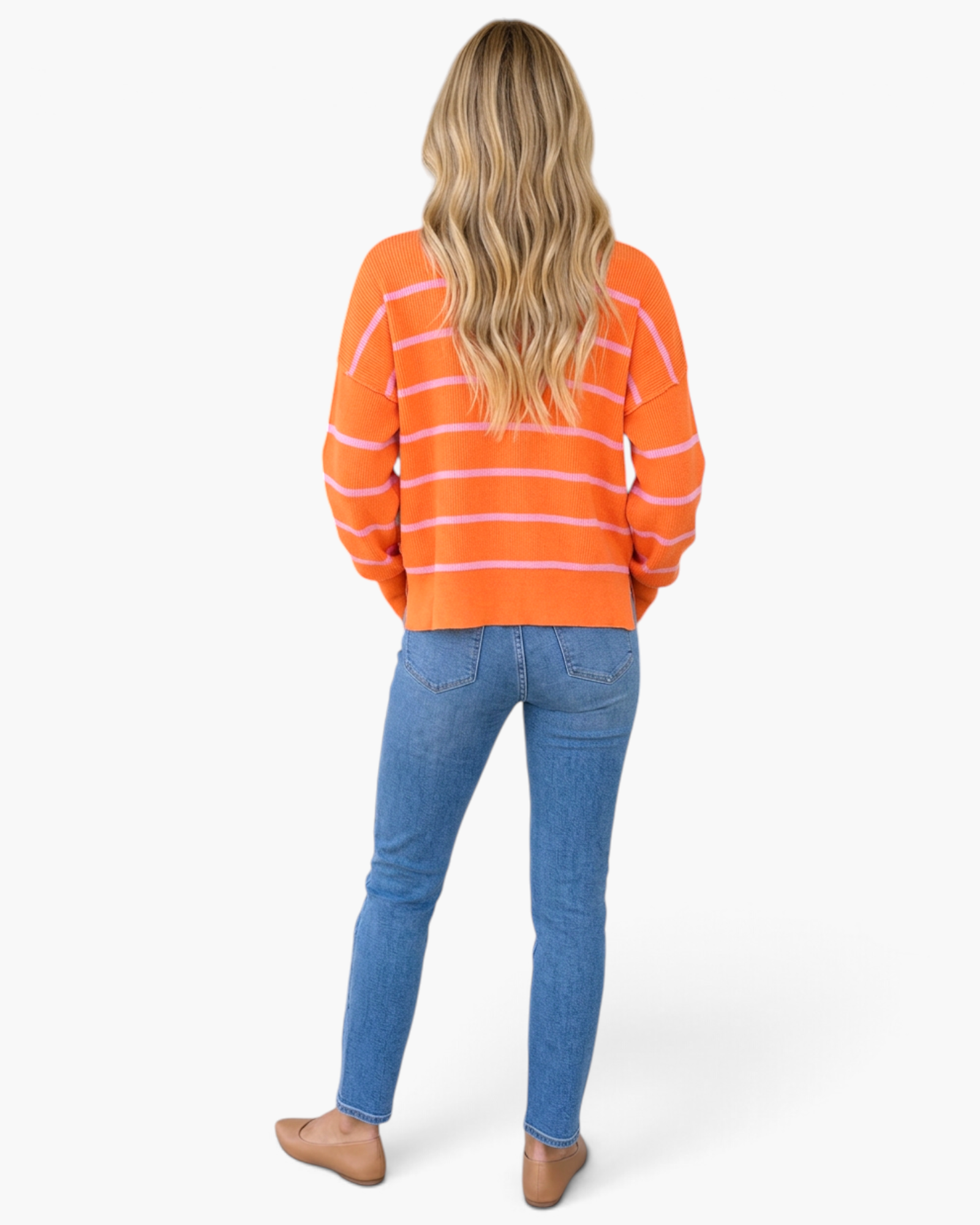 Beach Rose Co. orange and pink striped mock-neck sweater with long sleeves worn by a woman with blonde hair