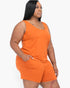 Beach Rose Co. plus size model wearing a vibrant orange stretchy jersey tank top and matching shorts set