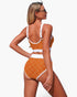 Beach Rose Co. orange polka-dot high-waisted bikini set with white contrast trim and adjustable straps on a model