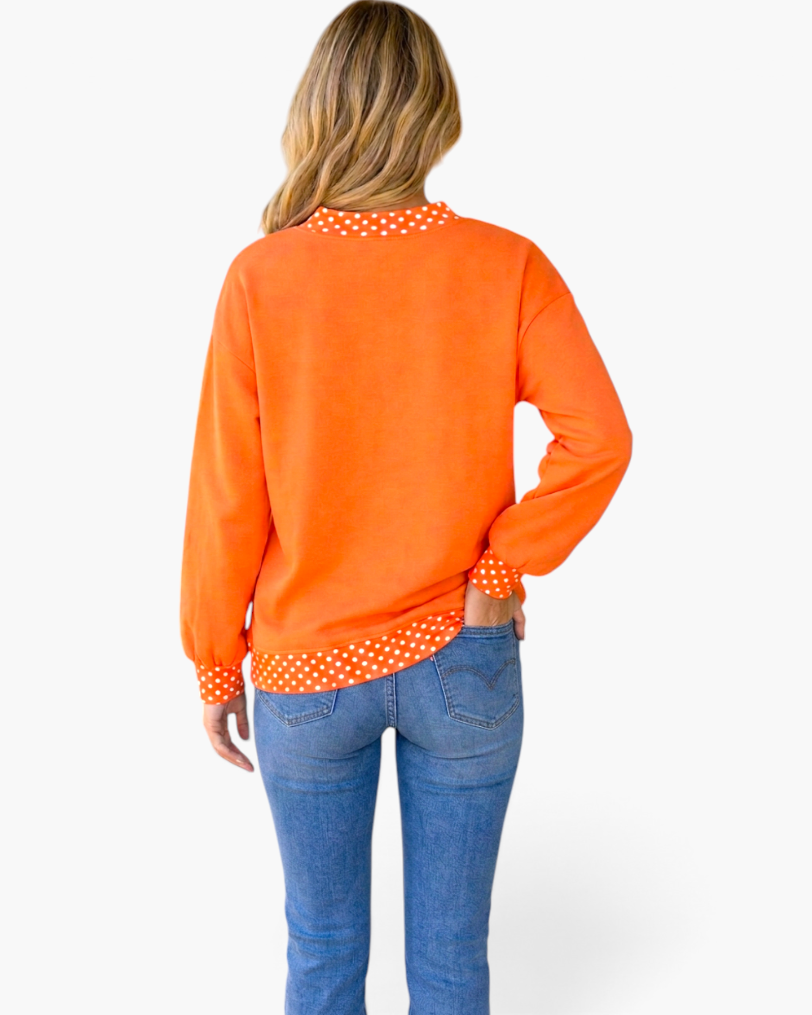 Beach Rose Co. orange sweatshirt with polka-dot trim on neckline, cuffs, and hem, worn with blue jeans, back view.