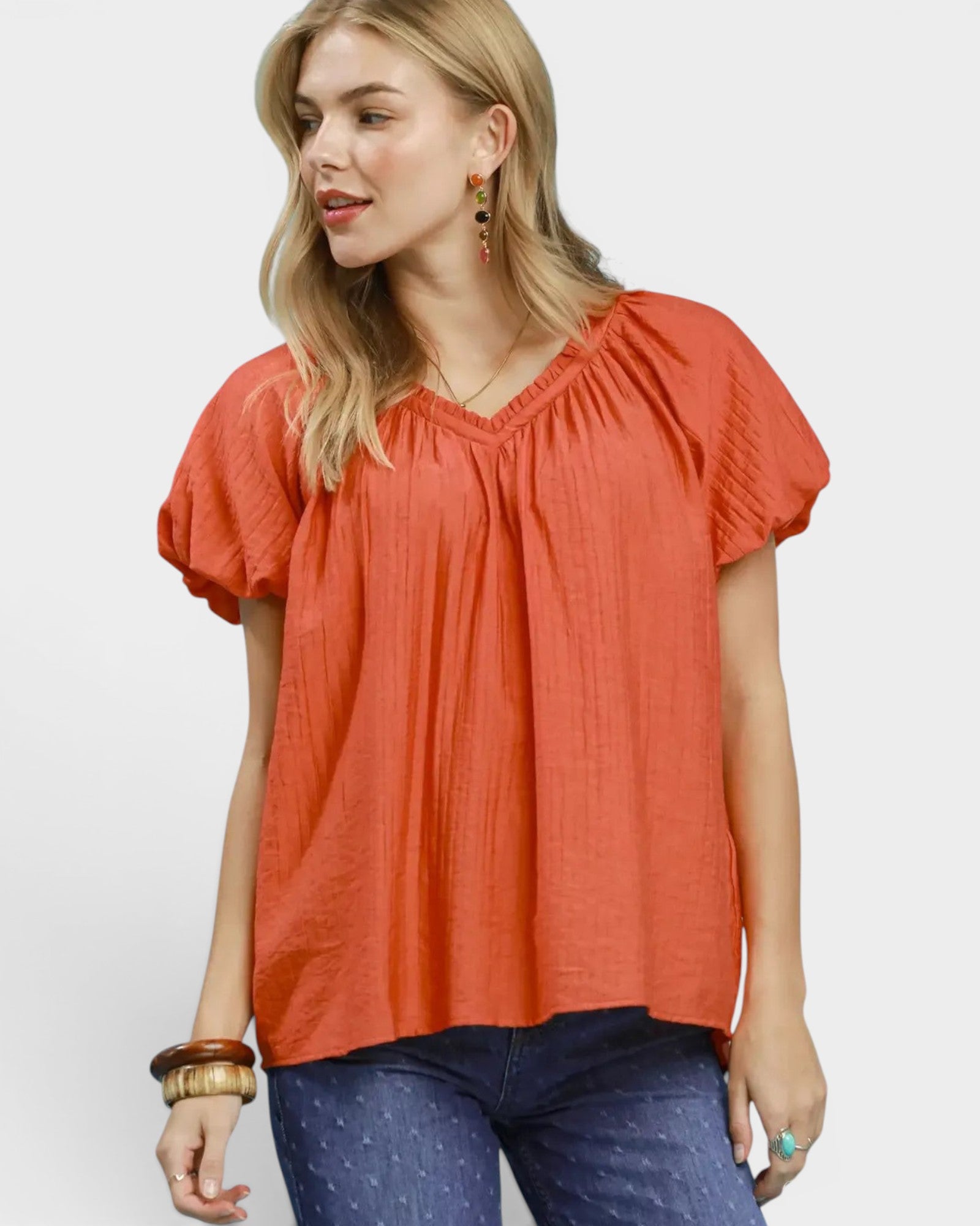 Beach Rose Co. orange puff sleeve blouse with gathered V-neckline and textured fabric. Relaxed fit, lightweight, and breathable.