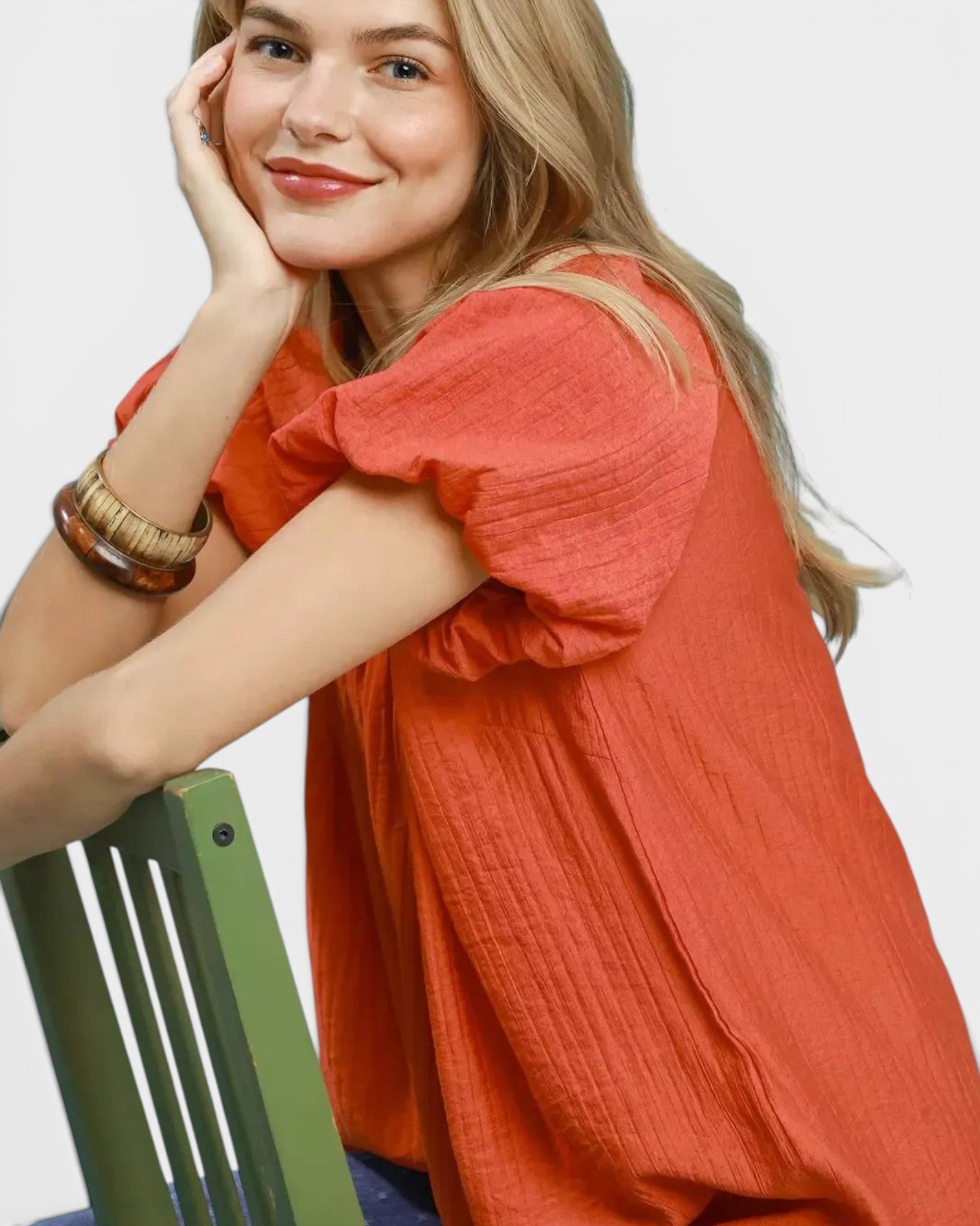 Beach Rose Co. orange puff sleeve blouse with gathered V-neckline and textured fabric. Relaxed fit, lightweight, breathable rayon-nylon blend.