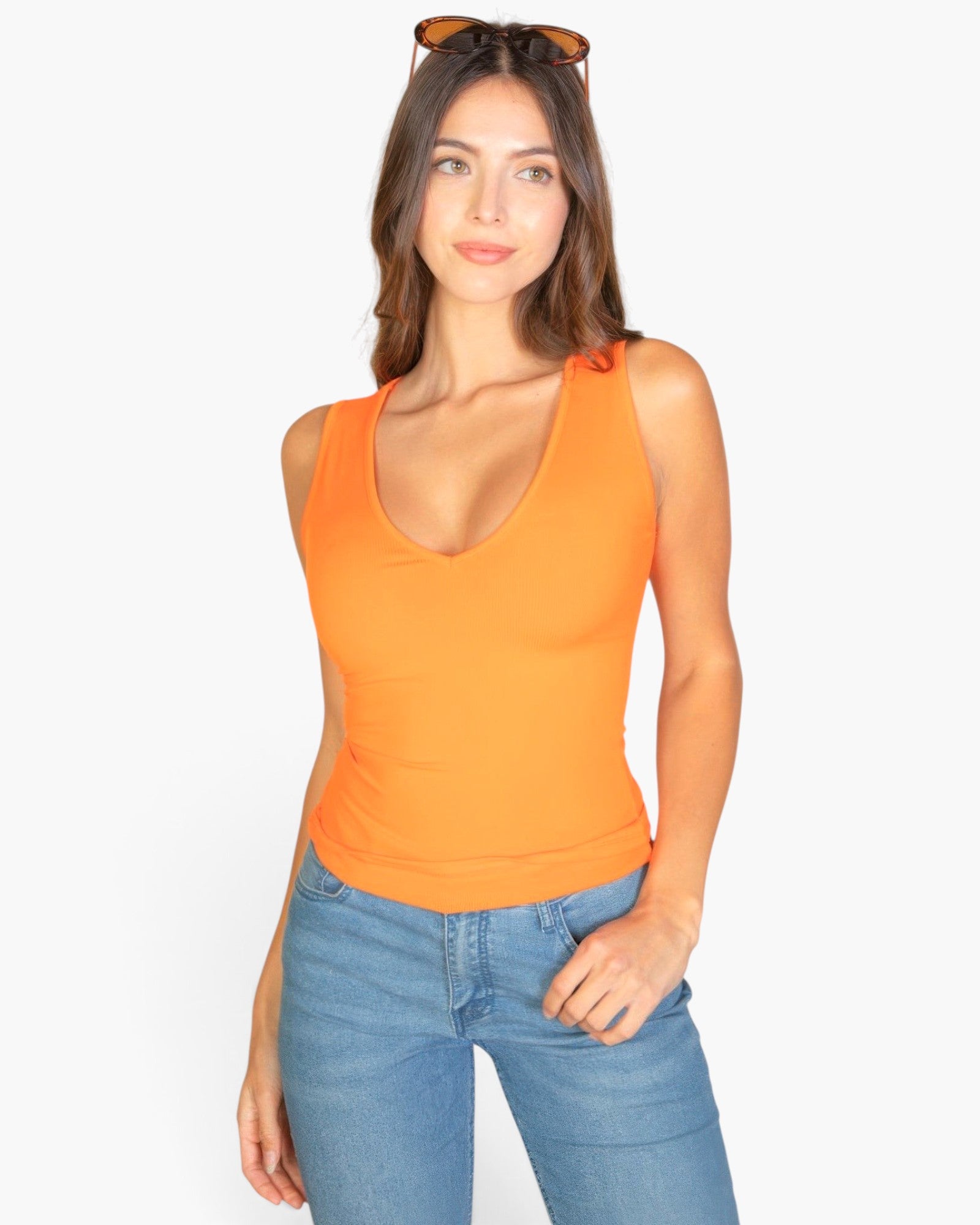 Beach Rose Co. orange ribbed V-neck sleeveless top worn by a woman with sunglasses on her head and blue jeans
