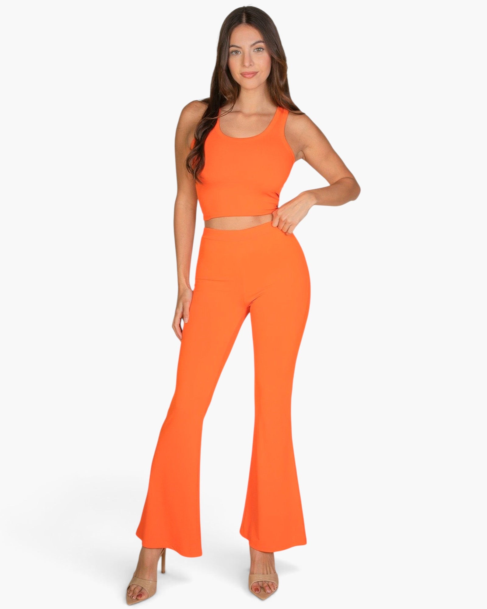 Beach Rose Co. model wearing an orange ribbed tank top and matching flared pants against a white background