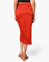 Beach Rose Co. orange washed satin crepe midi skirt with a side wrap design worn by a model from the back view