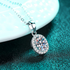 Beach Rose Co. silver oval moissanite pendant necklace with a zircon halo on a delicate sterling silver link chain.
