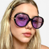 Beach Rose Co. oversized butterfly sunglasses with black frames and purple tinted lenses on a blonde woman