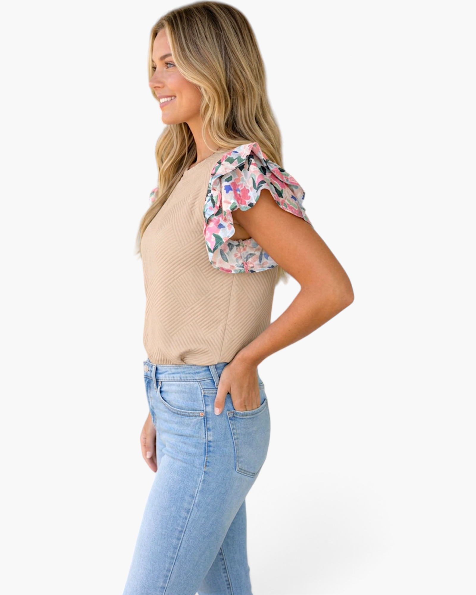 Beach Rose Co. parchment textured top with colorful floral layered ruffle sleeves worn by a woman in jeans