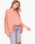 Model wearing a Beach Rose Co. peach washed poly silk caftan top with a boat neckline and flowy sleeves.