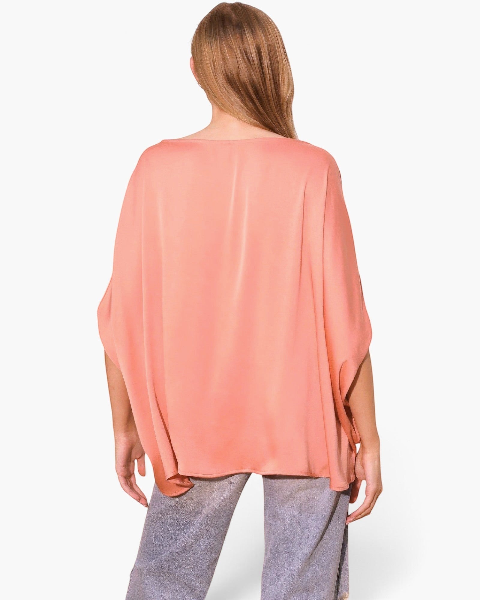 Beach Rose Co. peach washed poly silk caftan top with boat neck and flowy sleeves worn by a model from behind