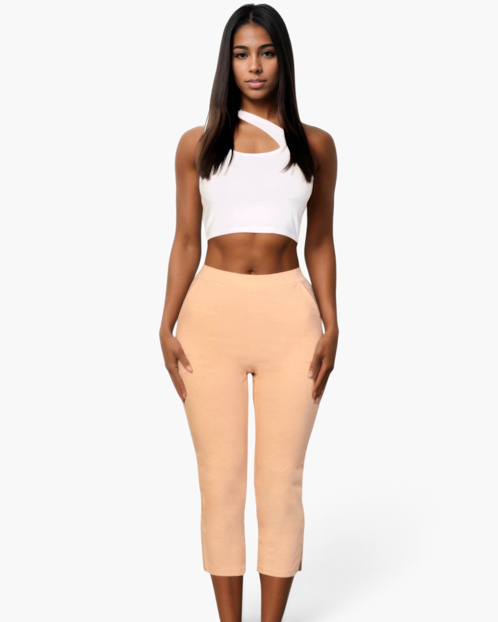 Beach Rose Co. peach cropped pants with slit hem detail worn by a model with a white asymmetrical crop top