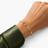 Beach Rose Co. gold filled bracelet featuring alternating synthetic pearls and small polished disc accents on a wrist.