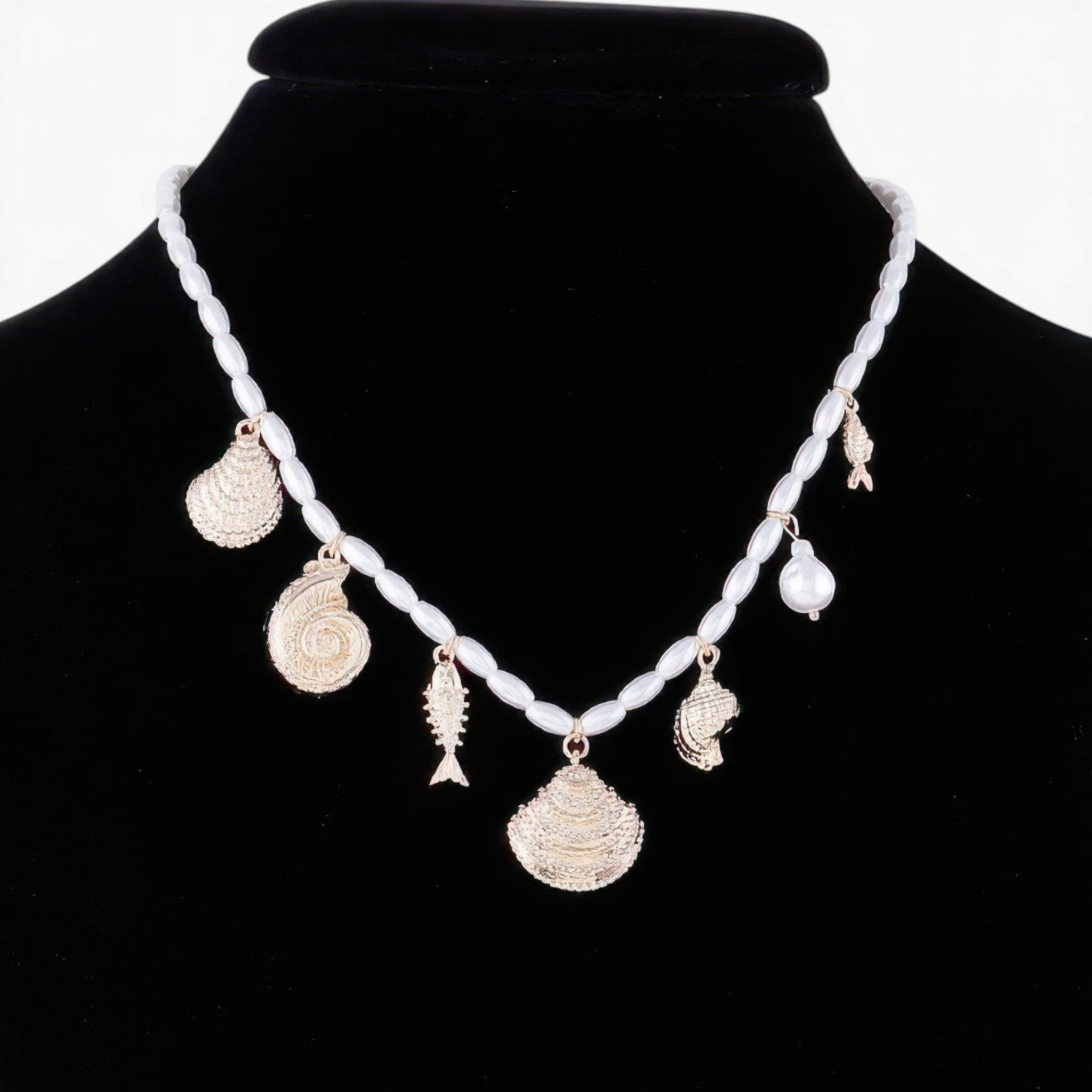 Beach Rose Co. Pearled Under the Sea charm necklace featuring gold-tone seashell and fish charms on a pearl chain.