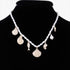 Beach Rose Co. Pearled Under the Sea charm necklace featuring gold-tone seashell and fish charms on a pearl chain.