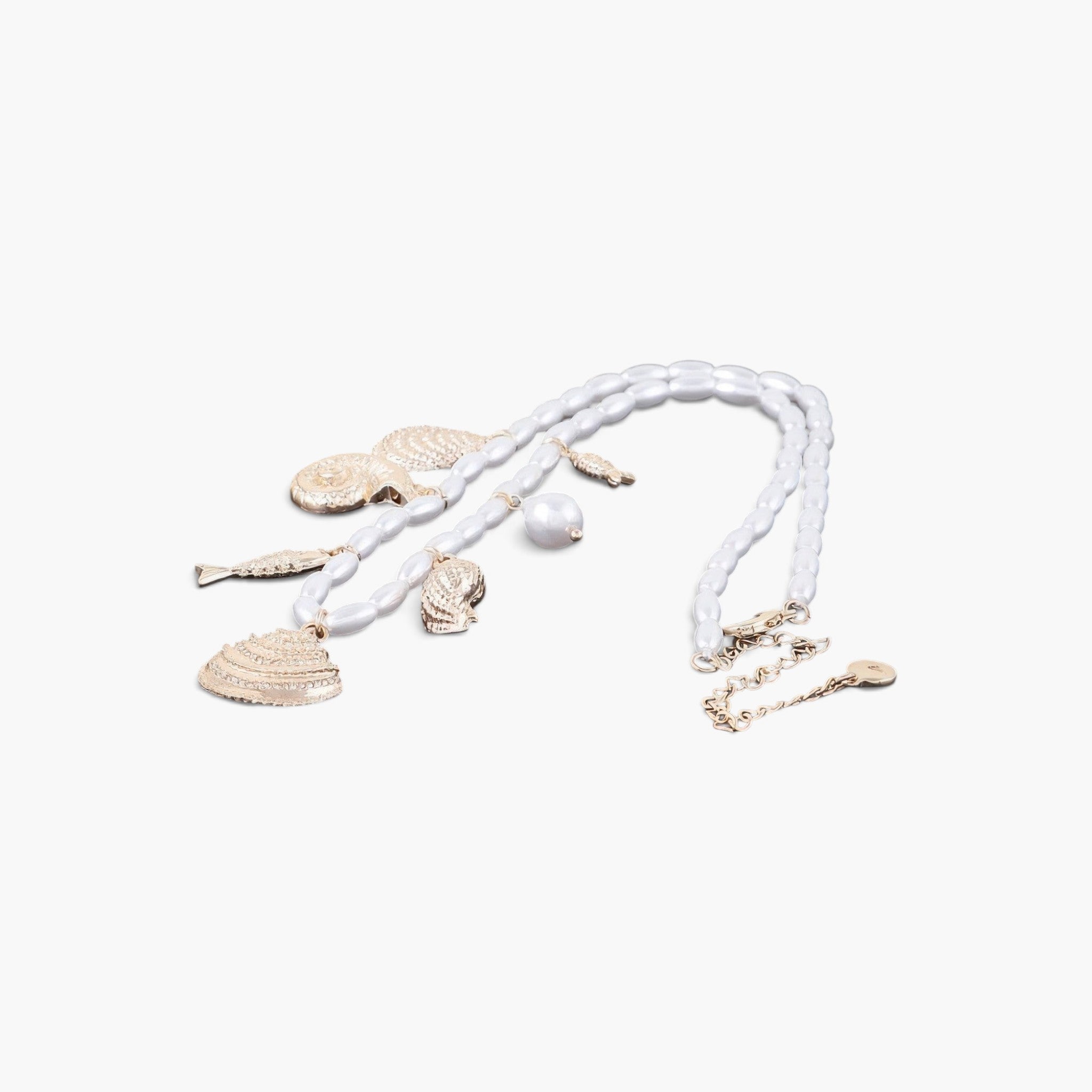 Beach Rose Co. Pearled Under the Sea charm necklace with gold-tone seashell charms and white pearl beads.
