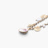 Beach Rose Co. gold chain necklace featuring delicate pearl and shell charms for a coastal-inspired look.