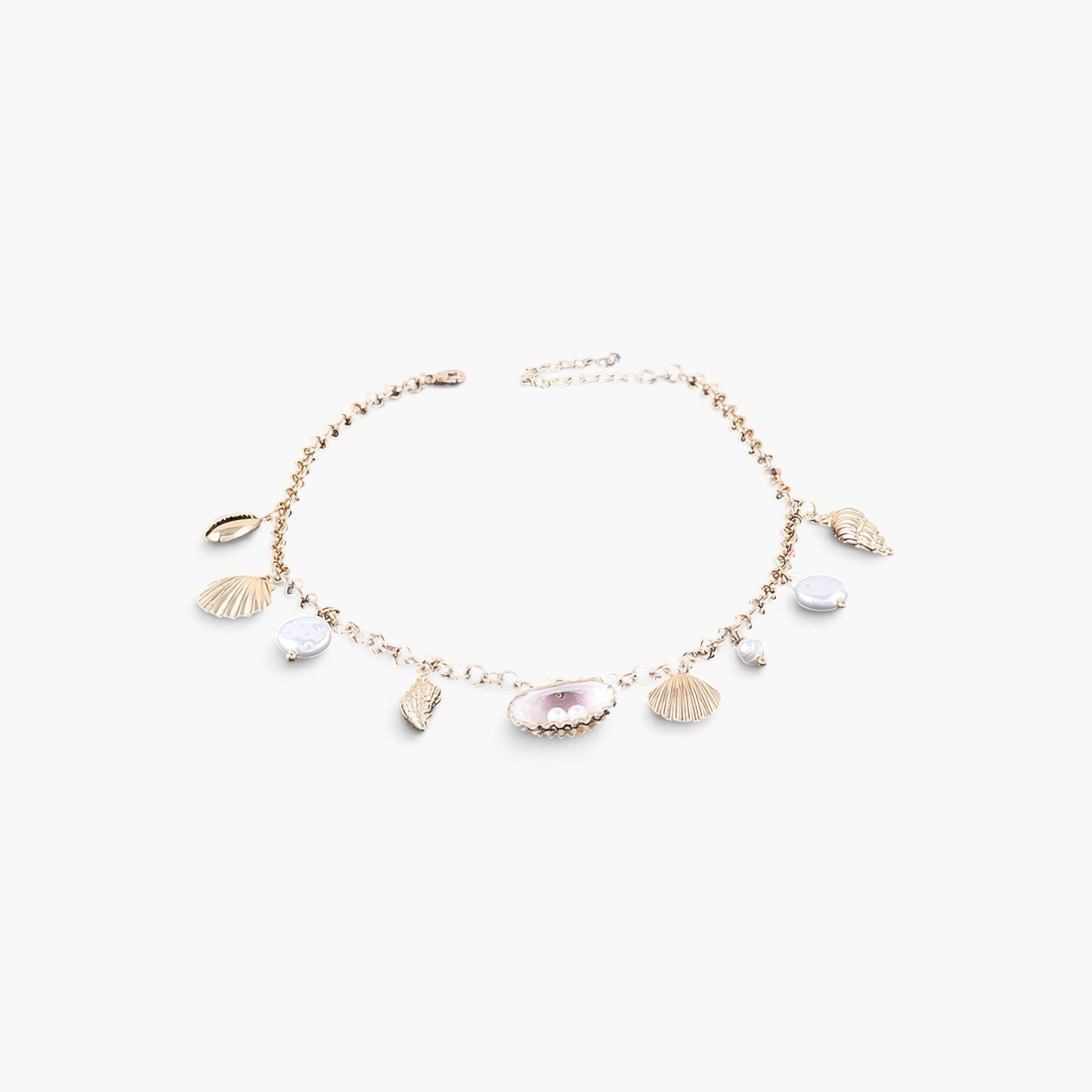 Beach Rose Co. gold chain necklace featuring delicate cream pearls and various seashell charms for a coastal look.
