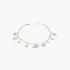 Beach Rose Co. gold chain necklace featuring delicate cream pearls and various seashell charms for a coastal look.