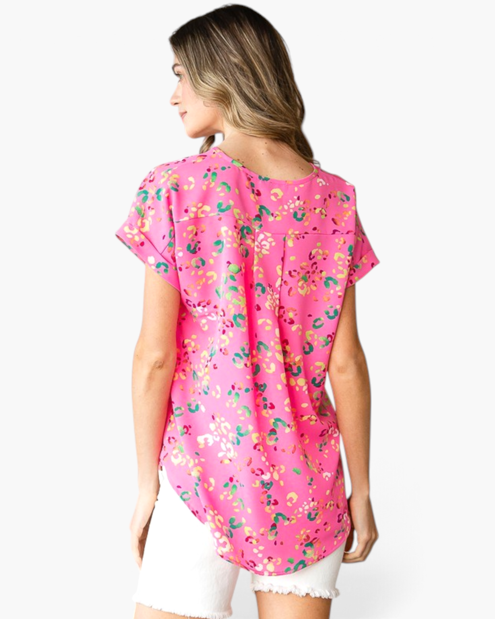 Beach Rose Co. pink abstract animal print top with cuffed short sleeves, back pleat, and curved hem on a model.