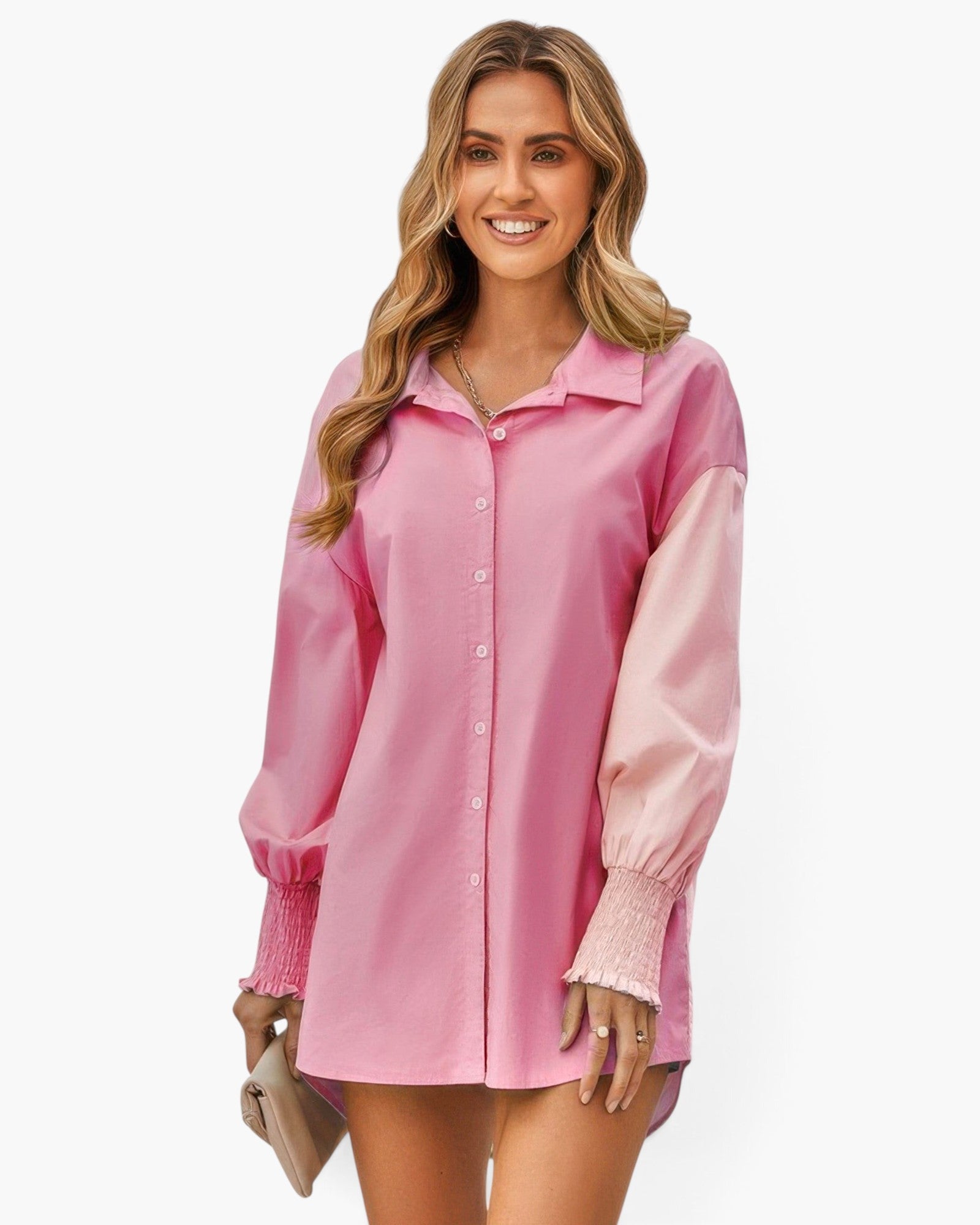 Beach Rose Co. pink color block button down blouse with long cuffed sleeves worn by a smiling woman