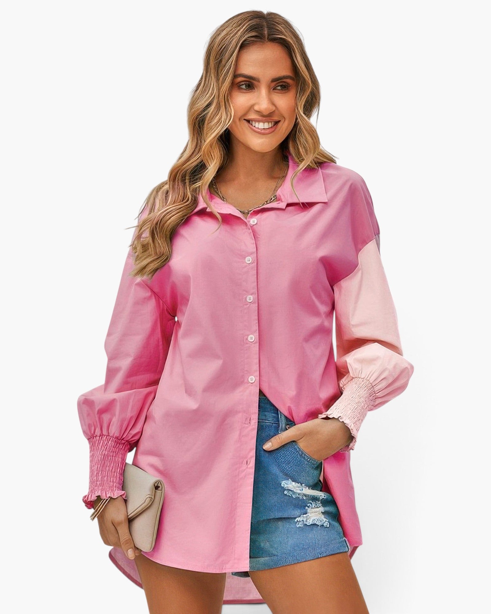 Beach Rose Co. pink color block button down blouse with cuffed sleeves worn by a smiling woman with denim shorts