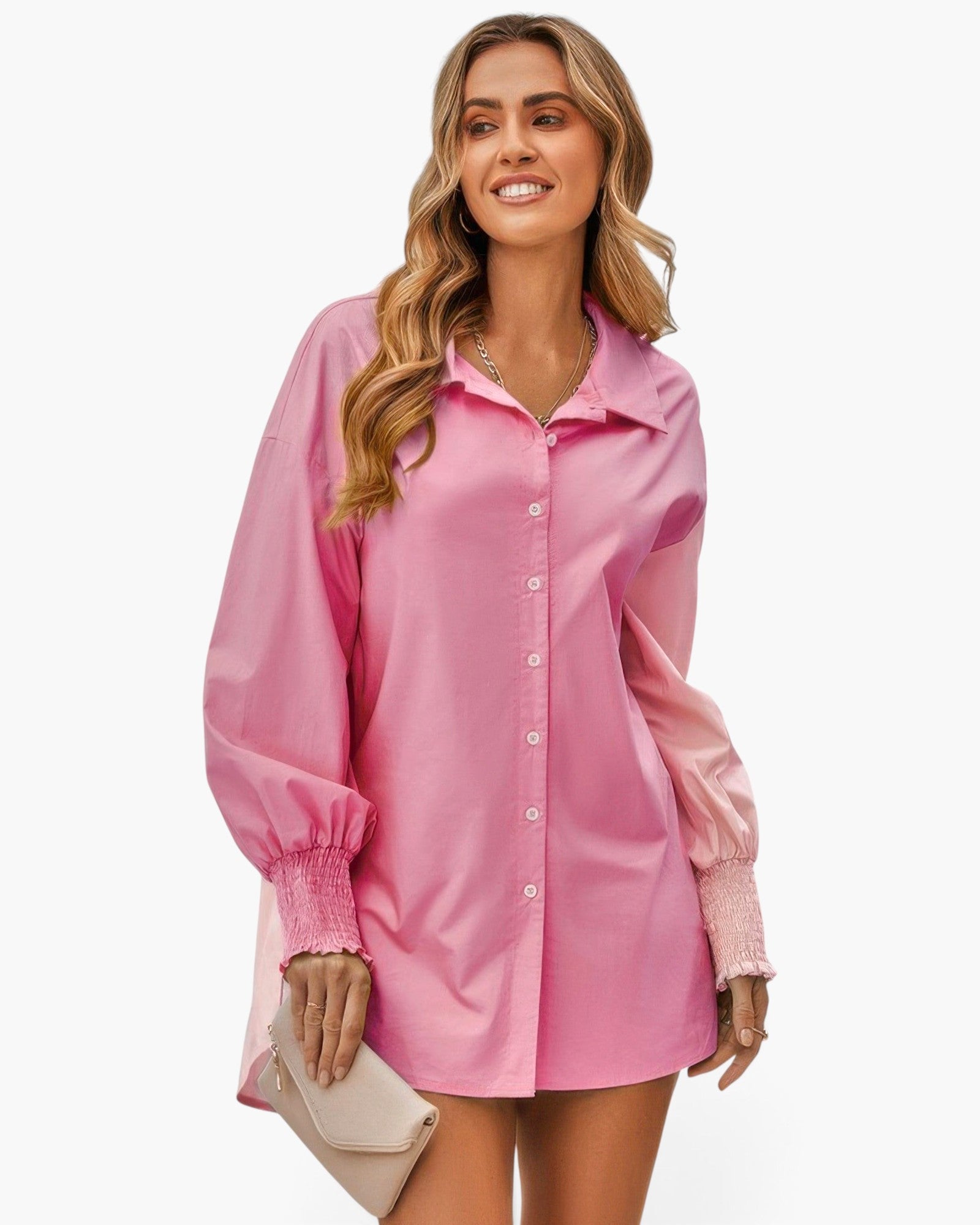 Beach Rose Co. pink color block button down blouse with cuffed sleeves worn by a smiling woman holding a clutch