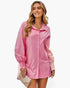 Beach Rose Co. pink color block button down blouse with cuffed sleeves worn by a smiling woman holding a clutch