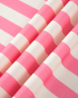 Beach Rose Co. pink and cream horizontal striped polyester blend fabric with soft folds