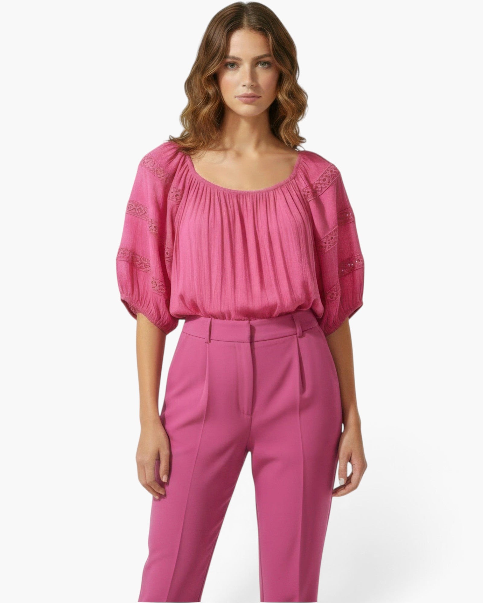 Beach Rose Co. pink short sleeve blouse with a scoop neckline and delicate crochet sleeve detailing on a model.