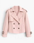 Beach Rose Co. light pink cropped double-breasted trench jacket with wide lapels, shoulder tabs, and buckled cuffs.