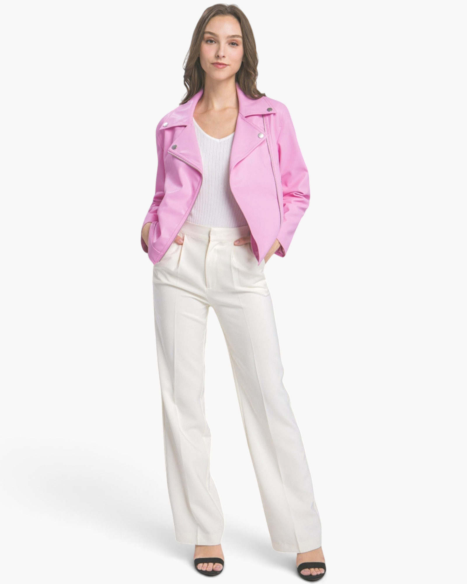 Model wearing a Beach Rose Co. bubblegum pink faux leather moto jacket with silver hardware over white trousers.