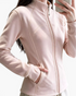 Beach Rose Co. pale pink fitted polyester zip-up jacket with stand collar, contoured seams, and side pockets.