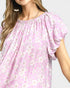 Beach Rose Co. pink floral print blouse with puff sleeves, gathered neckline, and back keyhole detail. Made of rayon and nylon.