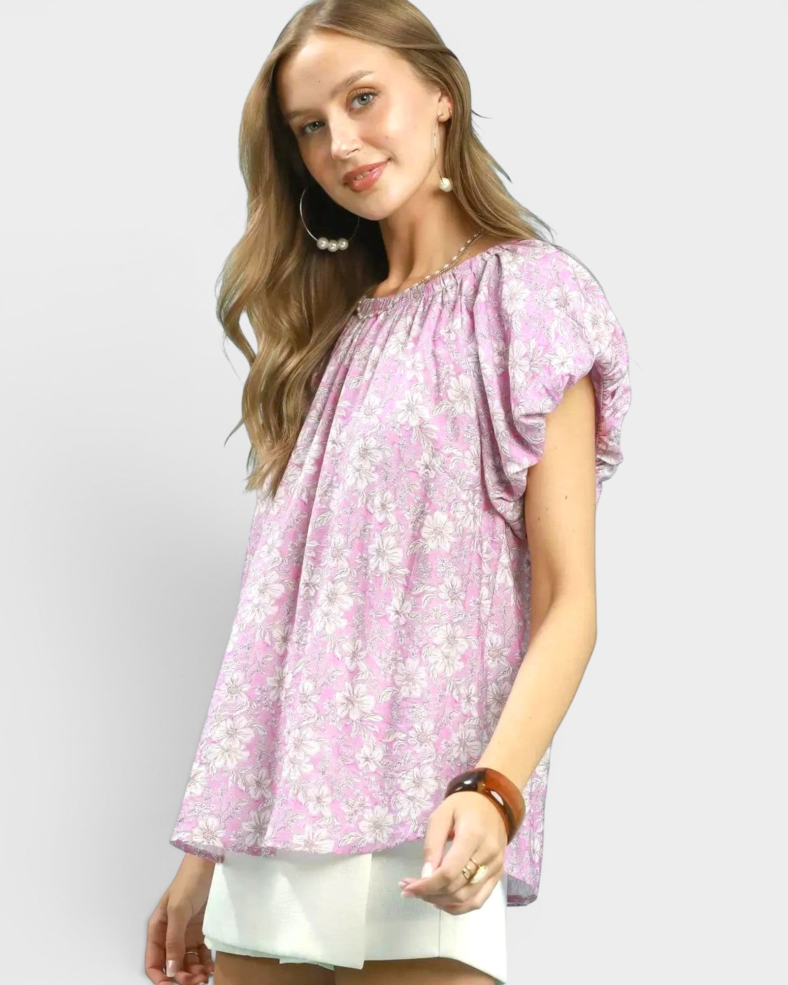 Beach Rose Co. pink floral puff sleeve blouse with gathered neckline and back keyhole detail. Made of rayon and nylon.