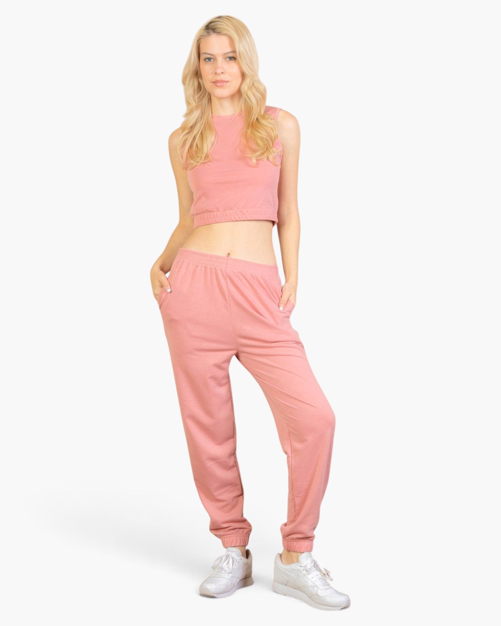 Beach Rose Co. rosewood pink French Terry tank top and joggers set worn by a blonde model with white sneakers.