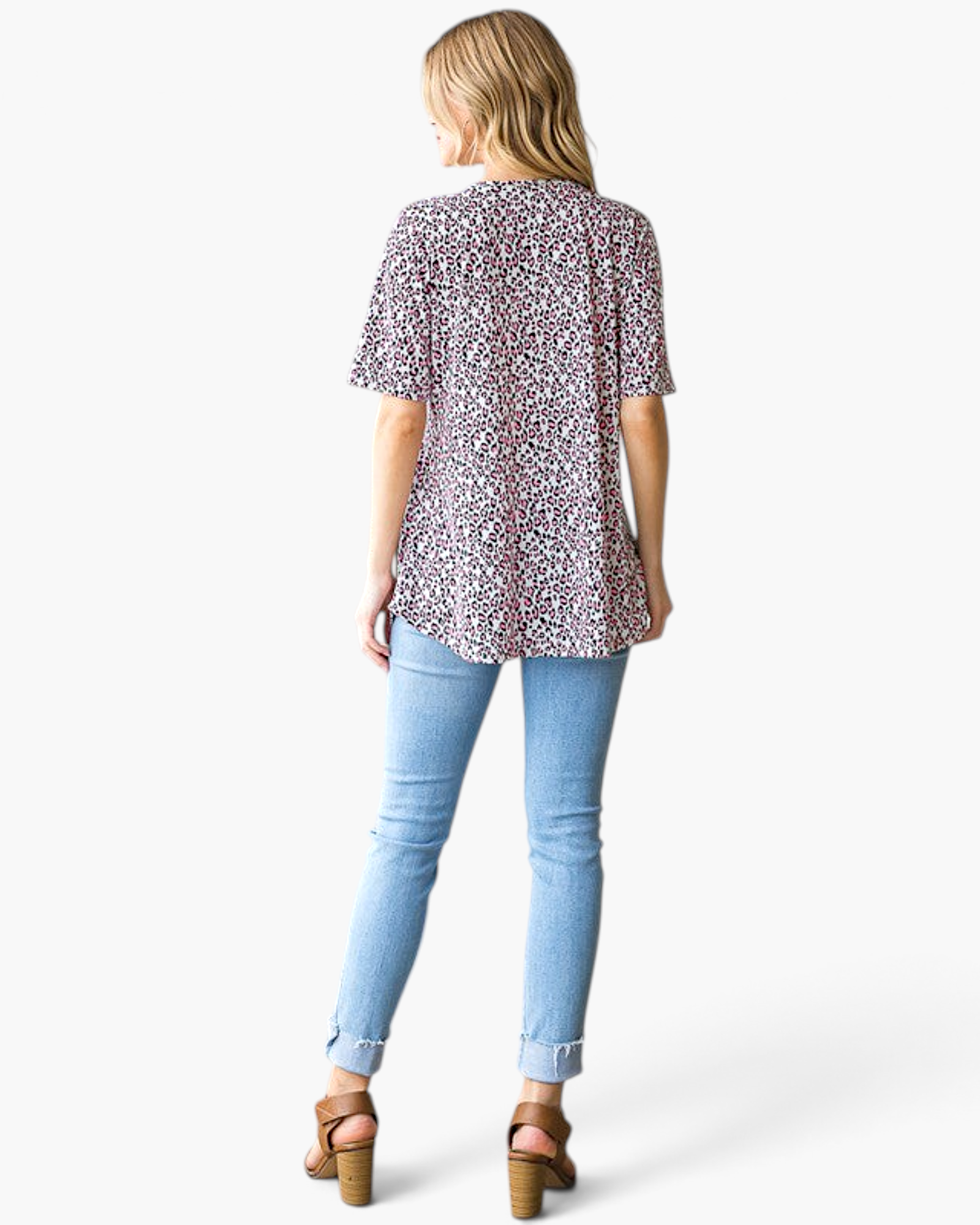 Beach Rose Co. pink leopard print babydoll top with short sleeves and curved hem, back view on a model in jeans.
