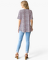 Beach Rose Co. pink leopard print babydoll top with short sleeves and curved hem, back view on a model in jeans.