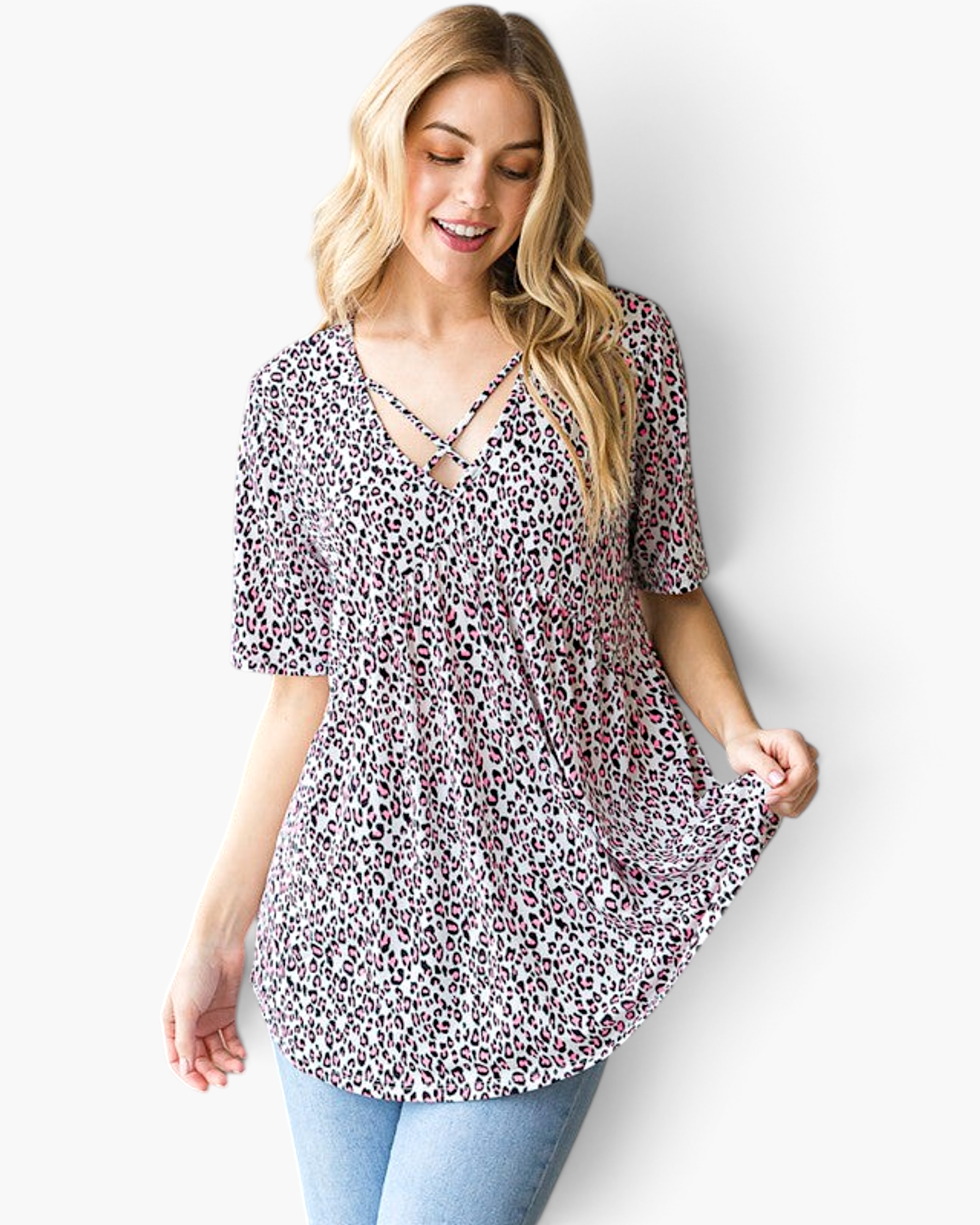 Beach Rose Co. pink leopard print babydoll top with a crisscross V-neckline and short sleeves on a smiling model