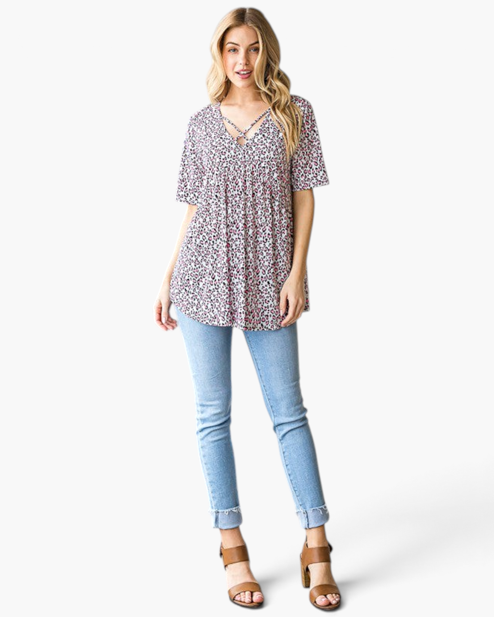 Beach Rose Co. pink leopard print babydoll top with a crisscross V-neckline worn with light wash jeans and sandals.