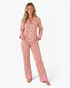 Beach Rose Co. pink leopard print pajama set with polka dot cuffs, button-front top, and matching long pants.