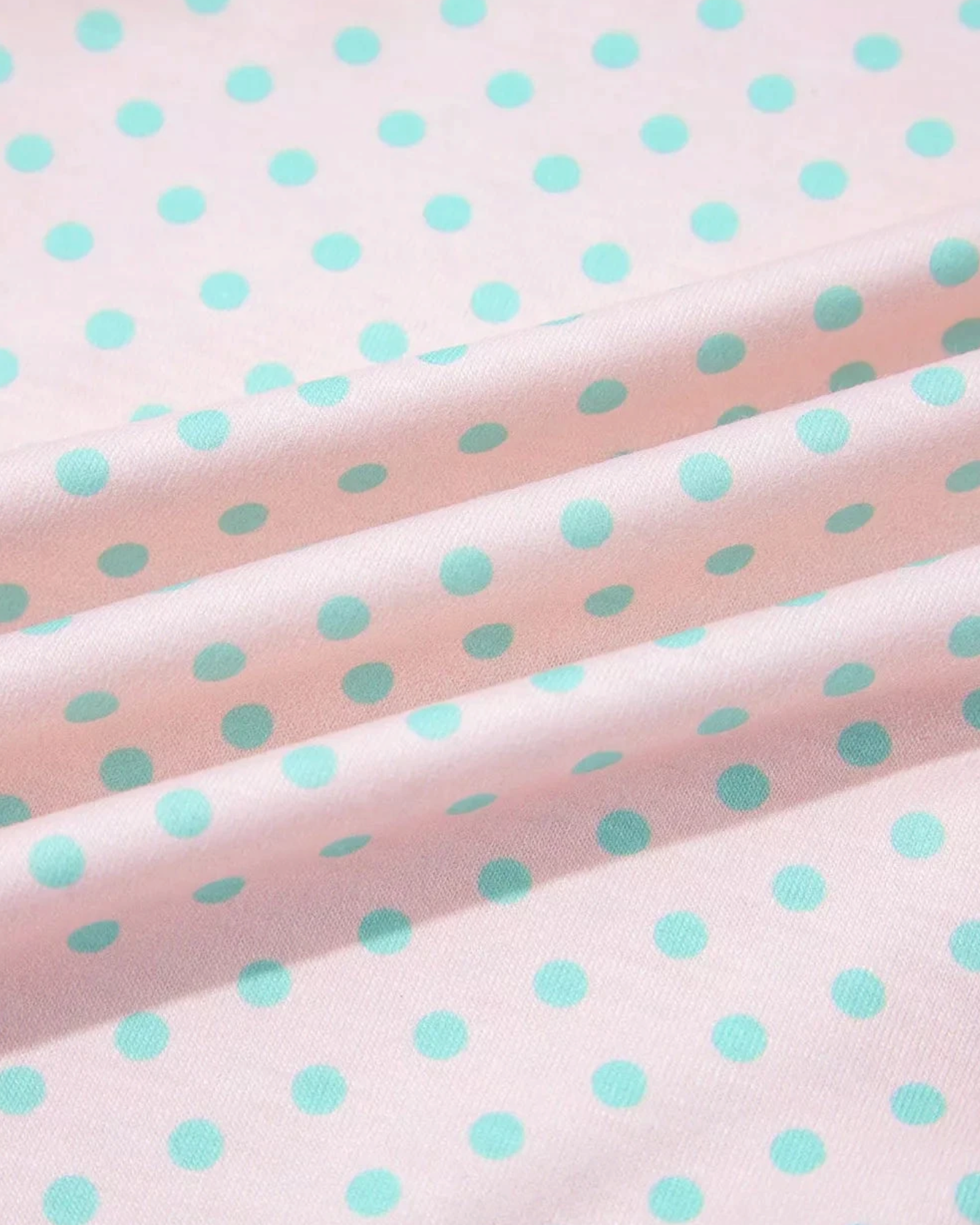 Beach Rose Co. cotton blend fabric with mint green polka dots on a soft pink background