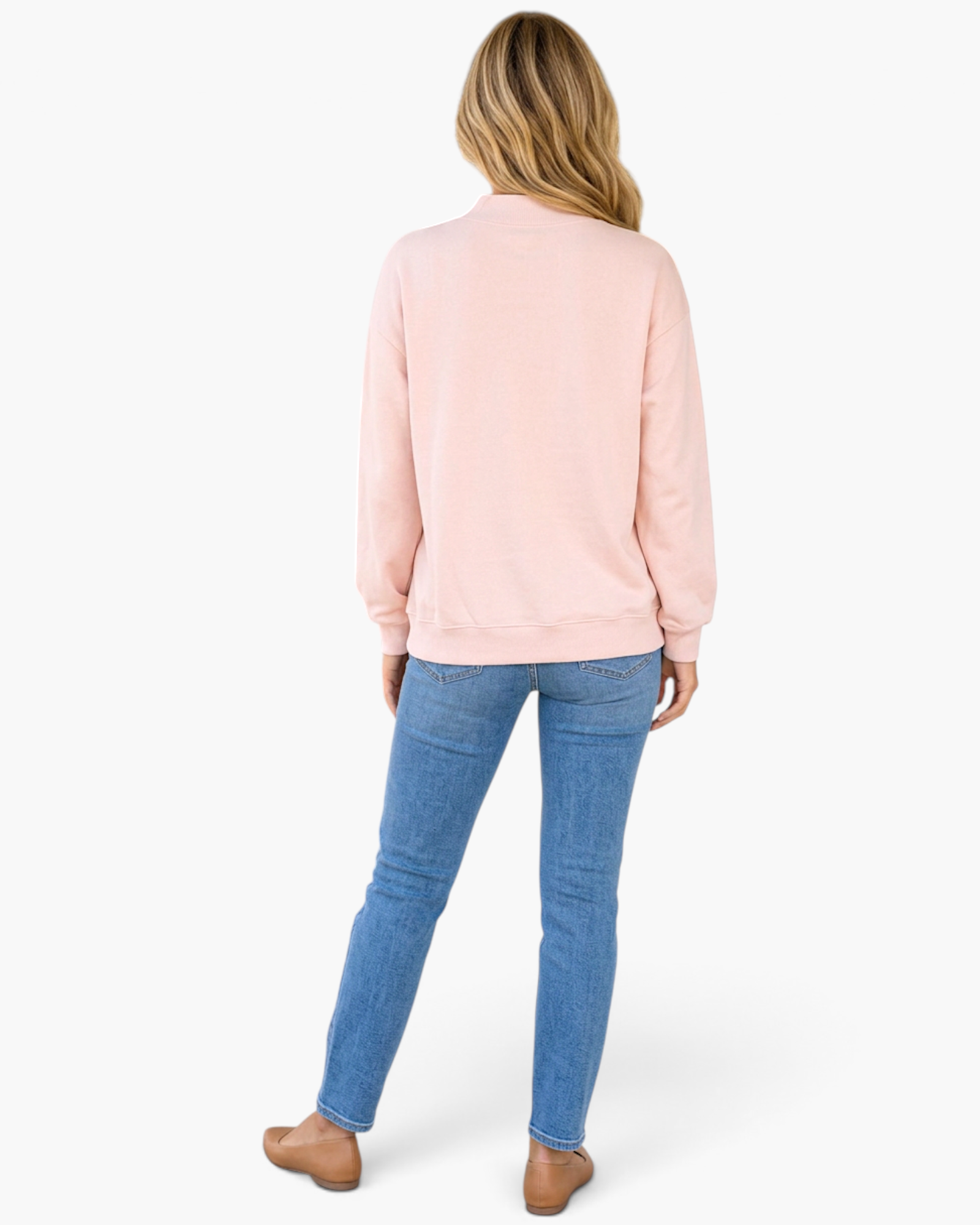 Beach Rose Co. pink baggy mock neck sweatshirt worn by a woman with blue jeans and tan flats, back view