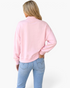 Beach Rose Co. pink mock neck cropped sweatshirt with dropped shoulders worn by a blonde model from the back view