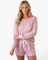 Beach Rose Co. dusty pink long sleeve lounge set with white polka dots, featuring a round neck and drawstring shorts.