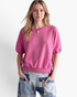 Beach Rose Co. pink raglan sweatshirt with elbow-length puff sleeves and a ribbed crew neckline on a blonde model.